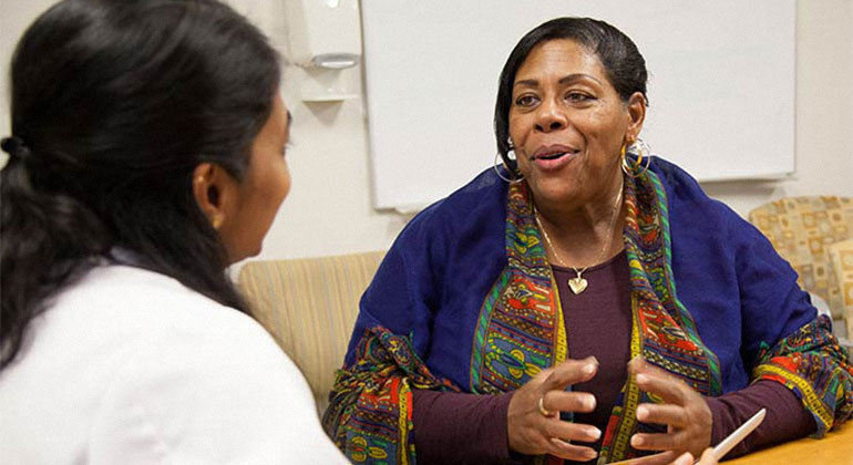 Patient talking to doctor in exam room