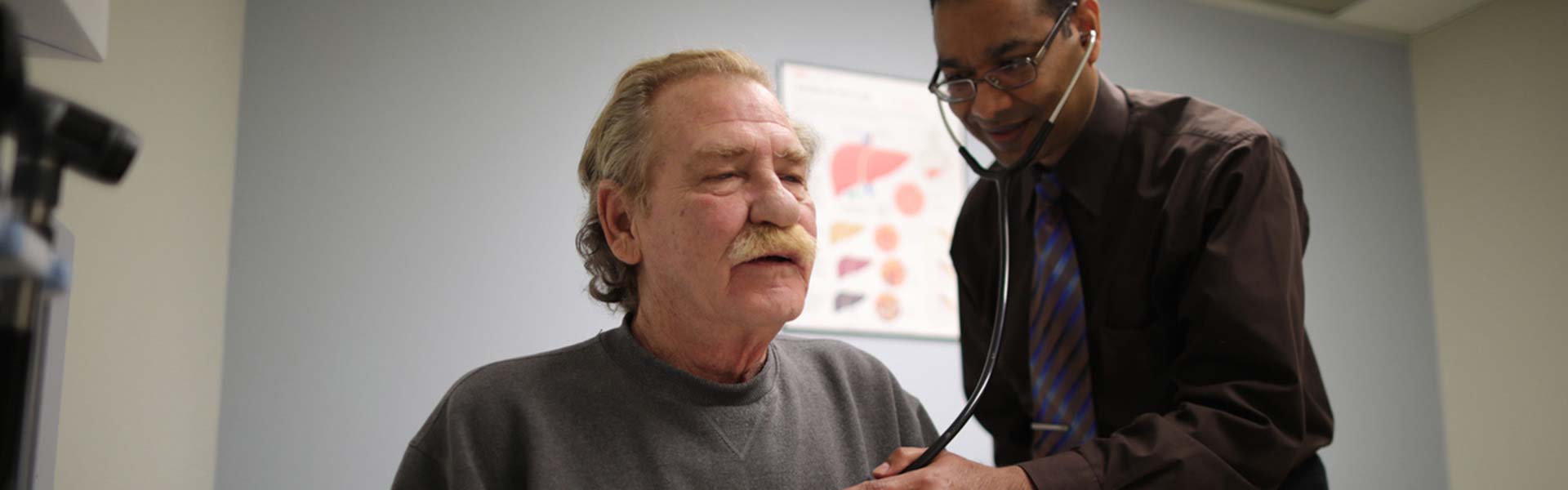 Doctor examining male patient