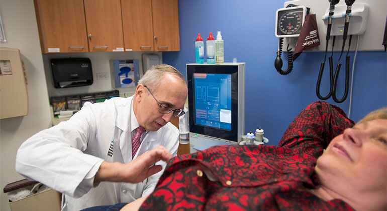 Image of doctor examining female patient