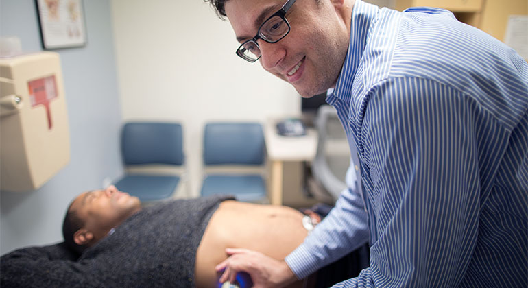 Image of doctor examining male patient