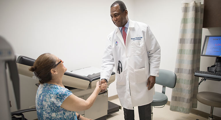 Image of doctor shaking hands with female patient