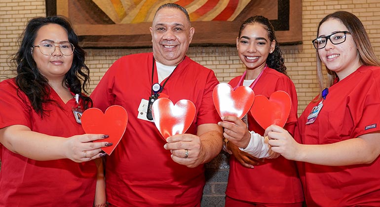 group of medical professionals holding hearts