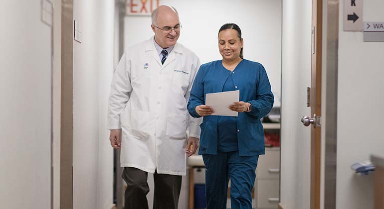 Doctor and nurse walking in hallway