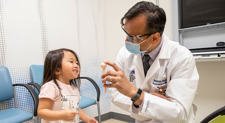 Masked doctor and young patient