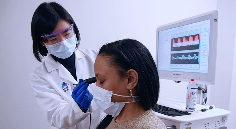 doctor using transcranial doppler ultrasound on patient