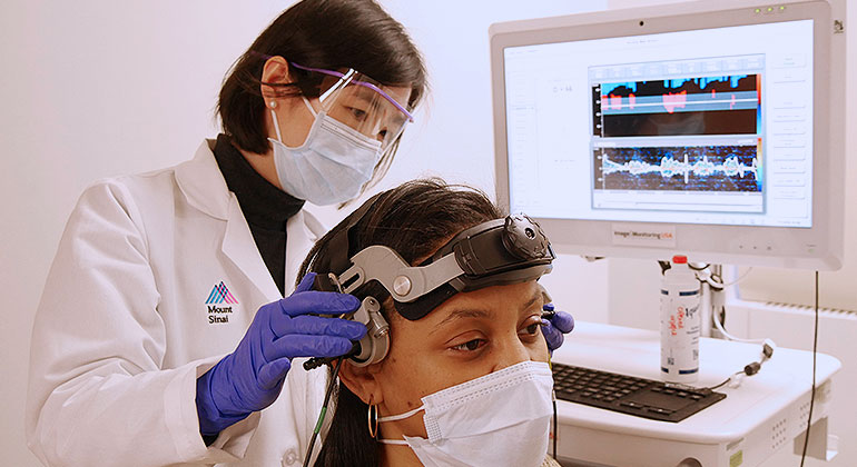 doctor using transcranial doppler ultrasound on patient