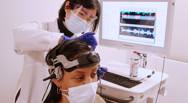doctor placing medical device on patient