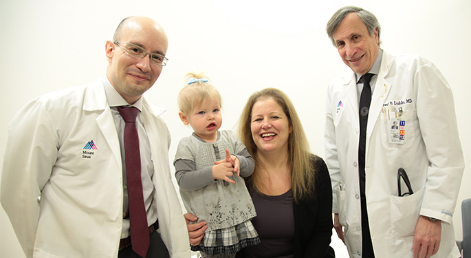 Image of Dr. Stephen Krieger and Dr. Fred Lublin with patient and child