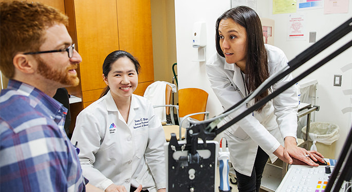 Image of Resident with Dr. Susan Shin and Dr. Jessica Robinson-Papp in lab