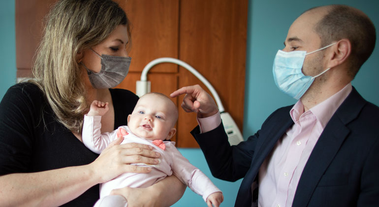 Image of doctor examining baby