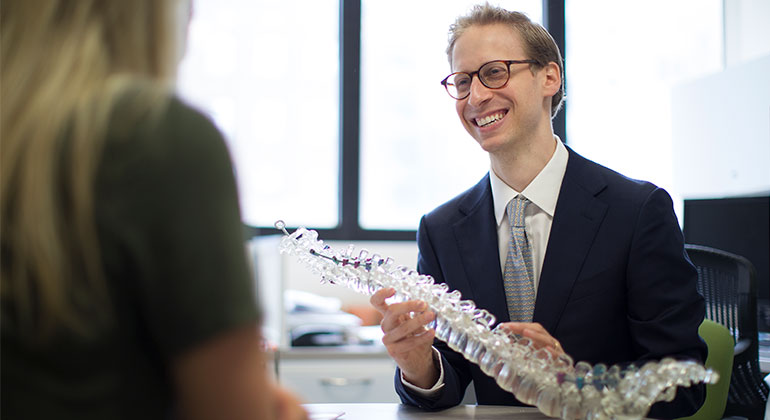 Doctor with model of spine