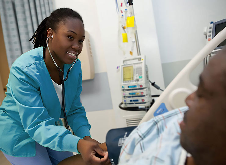 Photo of nursing helping a patient