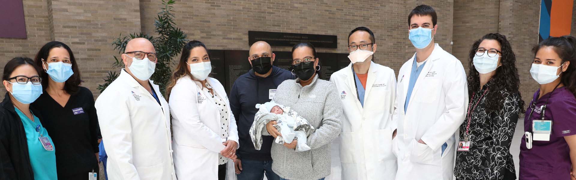 Image of doctors and mother holding baby