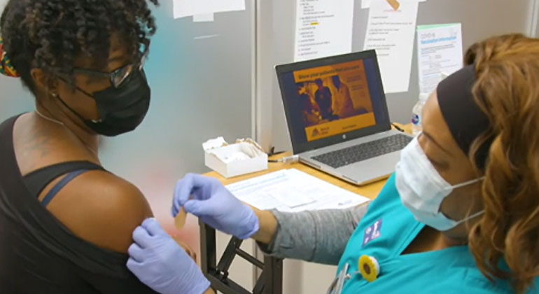 nurse placing band aid on patient 