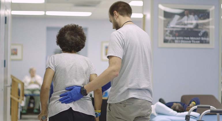 Health professional helping patient