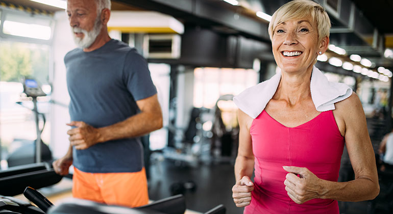 mature adults working out at the gym