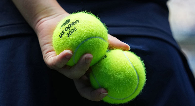 person holding two tennis balls