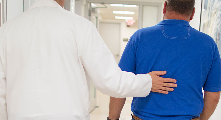 Doctor and patient walking in hallway