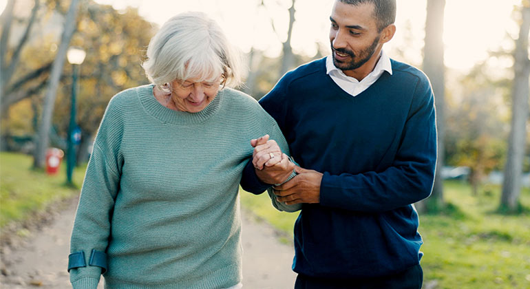 person assiting elderly person