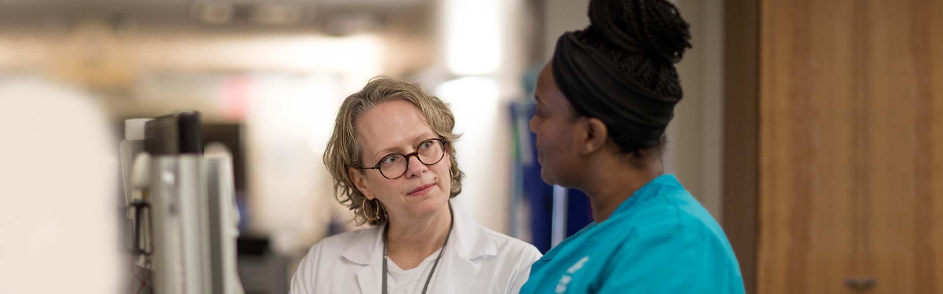 Female nurse manager consults with a fellow nurse