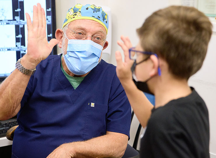 Photo of doctor giving a young patient a high five