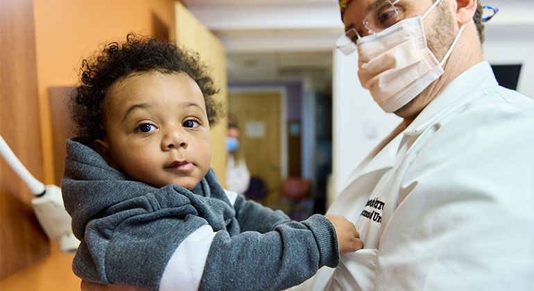 doctor holding child up