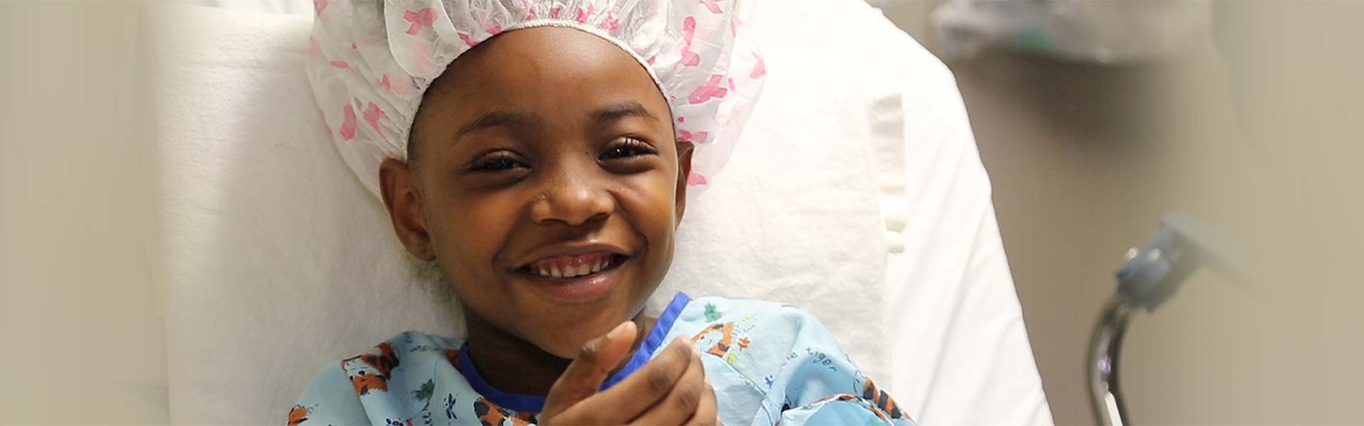 Little boy in surgical garb smiling
