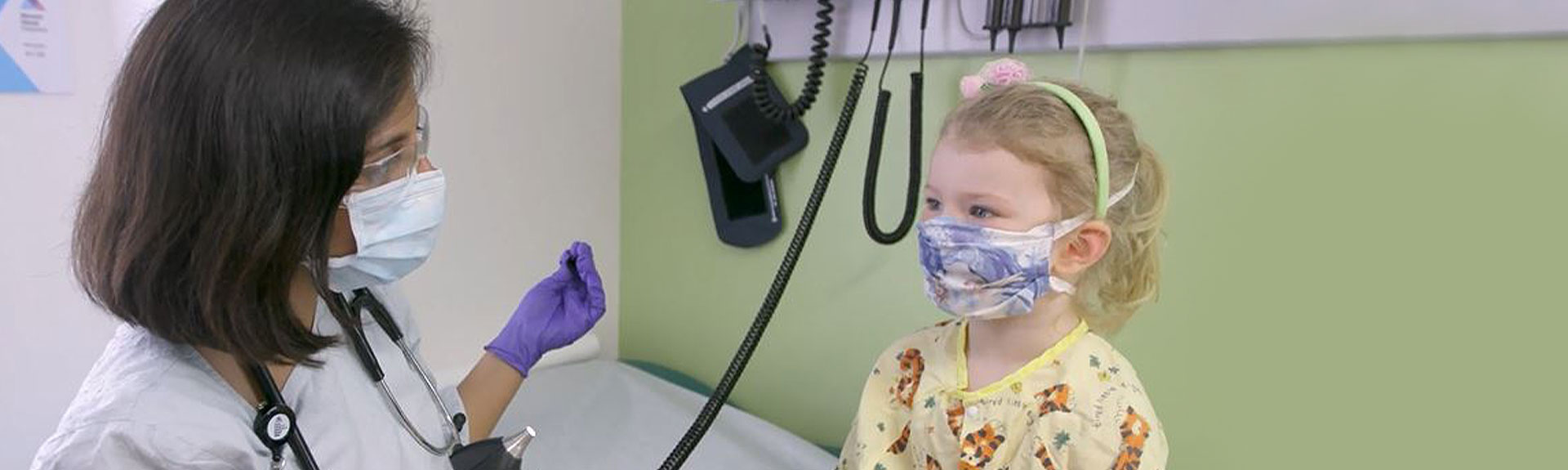 Image of doctor and small girl wearing masks