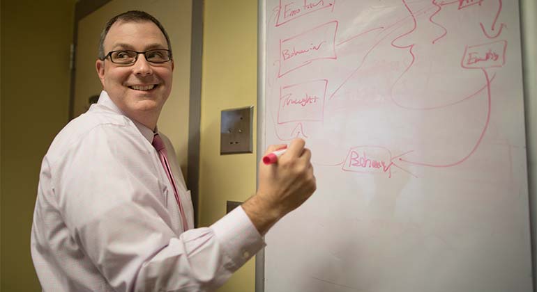 Doctor drawing flowchart on whiteboard