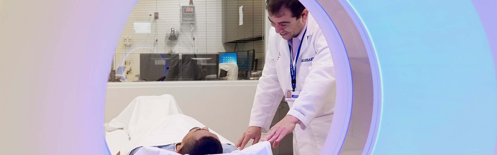 Imaging Technician with a patient in an imaging machine