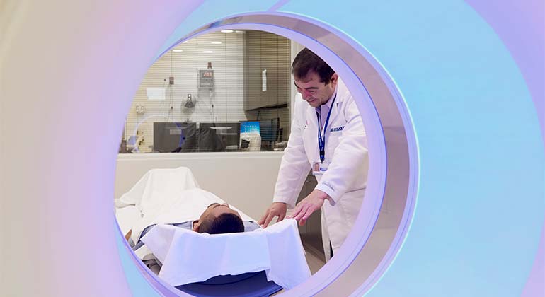 Imaging Technician with a patient in an imaging machine