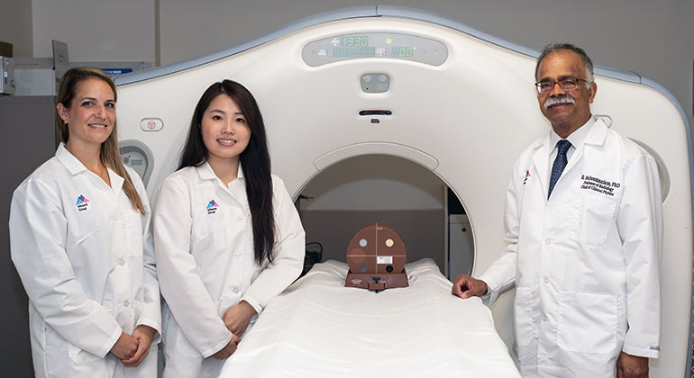 three doctor in front of MRI machine