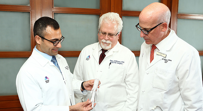 Doctors looking at stent graft