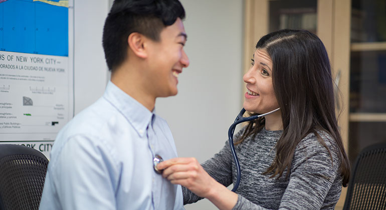 Image of doctor examining male patient