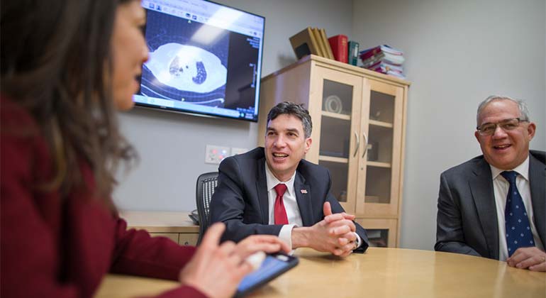 Image of doctors talking in round table