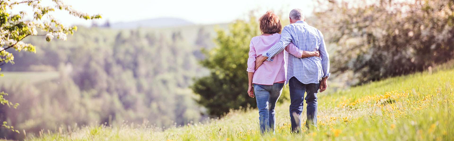 Older Couple walking on a hill