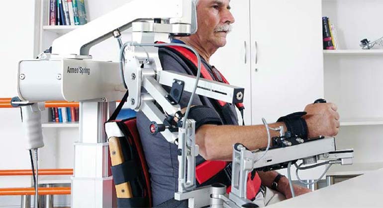 Male seated in robotic chair