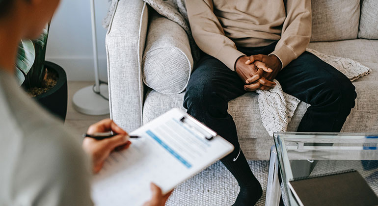 image of individual on a couch across from evaluator