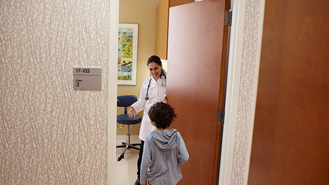 Infant walking into doctor