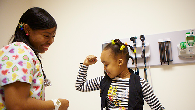 Young patient fist bumping doctor