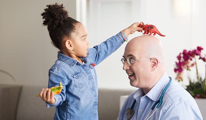 Little girl playing with doctor