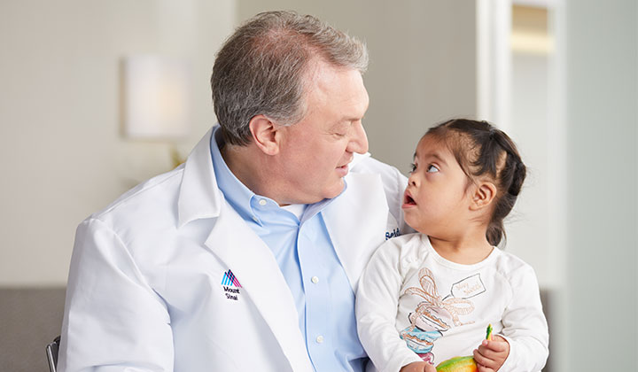 Doctor and little girl looking at each other