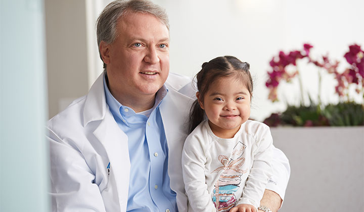 Doctor and little girl smiling