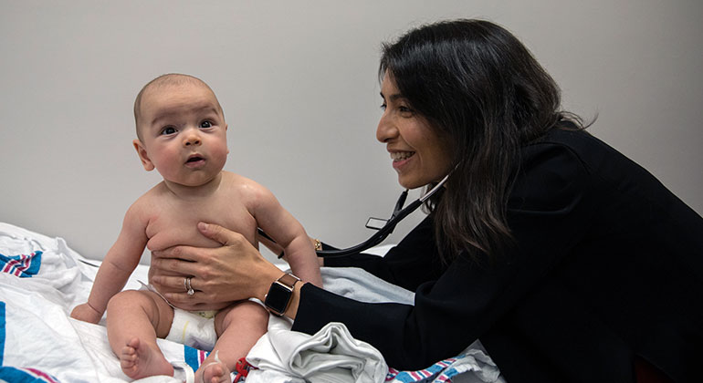 doctors checks infant patient