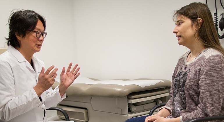 Doctor talking to female patient at Center for Transgender Medicine and Surgery