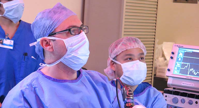 Doctors in masks performing procedure