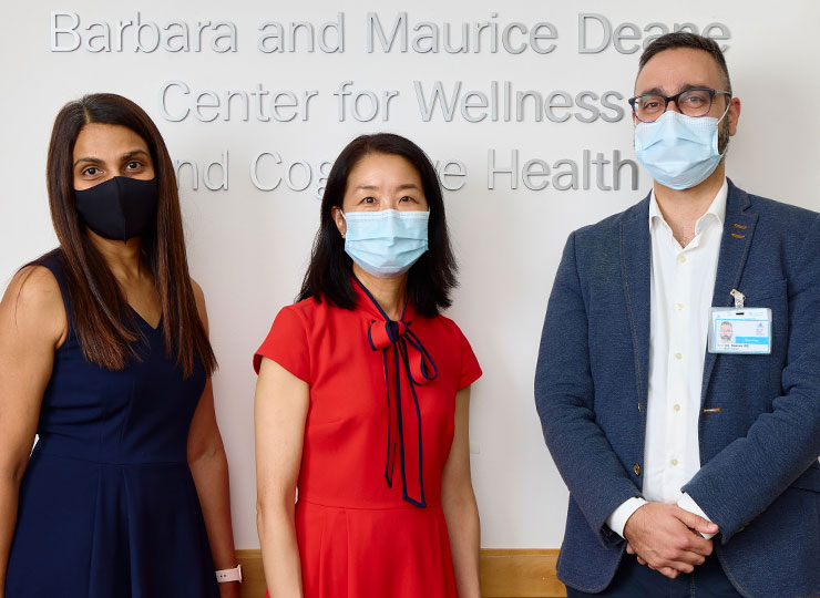 Photo of doctors wearing masks standing in front of Center's sign