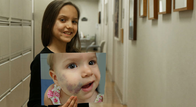 Child holding her baby picture