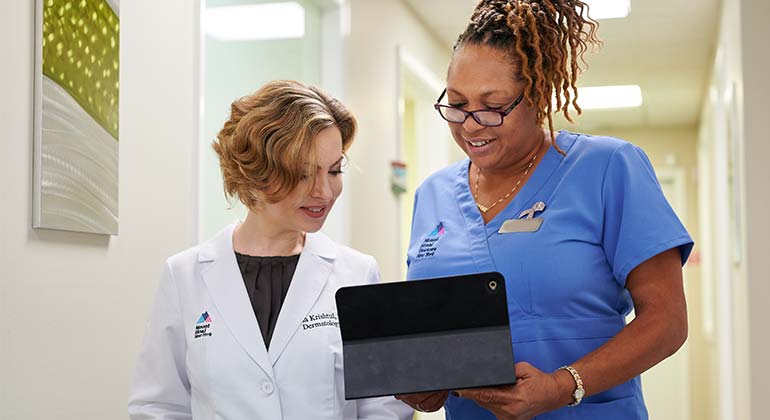 Doctor and nurse looking at laptop screen