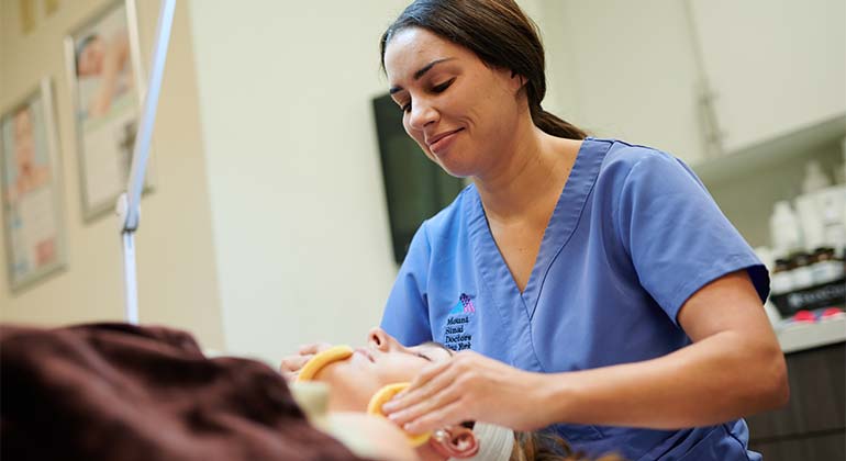 Nurse applying facial treatment to patient